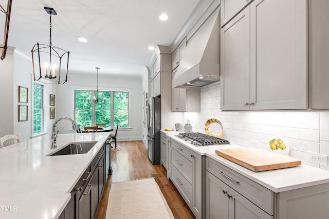 197 Boxwood Dr, Pittsboro, NC 27312 - kitchen with a sink, appliances with stainless steel finishes, premium range hood, a chandelier, and gray cabinets