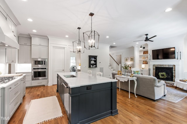 197 Boxwood Dr, Pittsboro, NC 27312 - kitchen featuring appliances with stainless steel finishes, a sink, gray cabinets, a stone fireplace, and recessed lighting