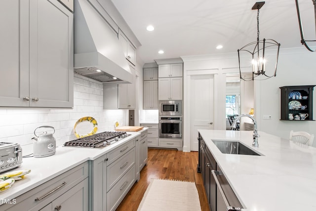 197 Boxwood Dr, Pittsboro, NC 27312 - kitchen with a sink, appliances with stainless steel finishes, custom exhaust hood, gray cabinetry, and light countertops