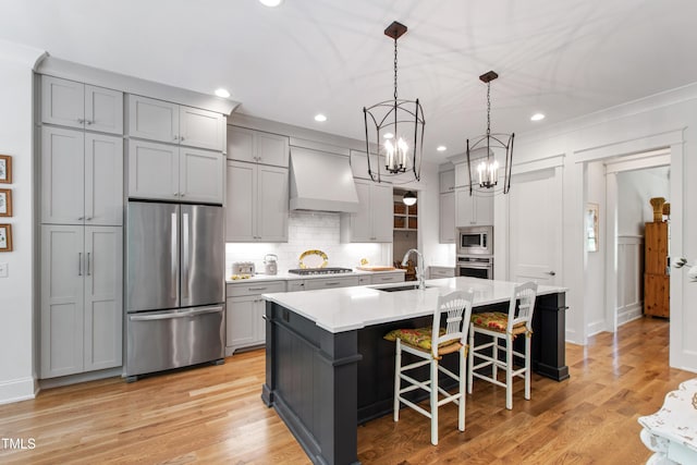 197 Boxwood Dr, Pittsboro, NC 27312 - kitchen featuring appliances with stainless steel finishes, custom range hood, gray cabinetry, tasteful backsplash, and recessed lighting