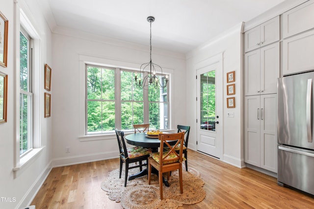 197 Boxwood Dr, Pittsboro, NC 27312 - dining area featuring healthy amount of natural light, light wood finished floors, and a chandelier