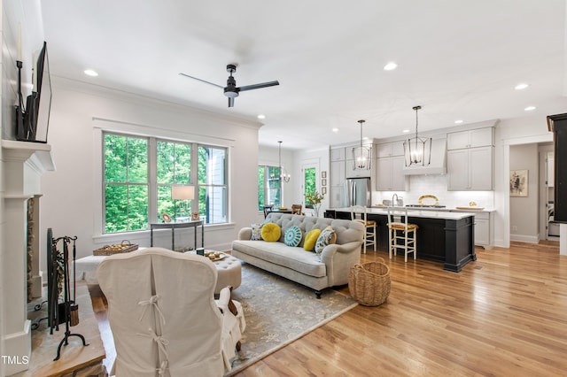 197 Boxwood Dr, Pittsboro, NC 27312 - living area featuring ceiling fan, recessed lighting, light wood finished floors, crown molding, and a fireplace