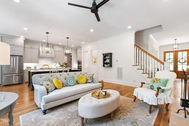 197 Boxwood Dr, Pittsboro, NC 27312 - living room featuring a chandelier, ceiling fan, recessed lighting, light wood-style floors, and french doors