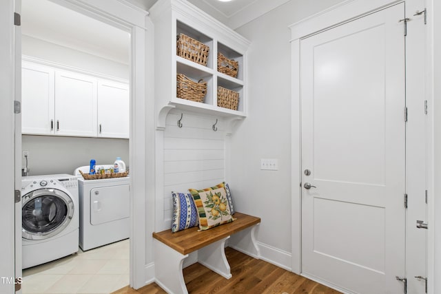 197 Boxwood Dr, Pittsboro, NC 27312 - washroom featuring independent washer and dryer, light wood-style floors, cabinet space, and baseboards