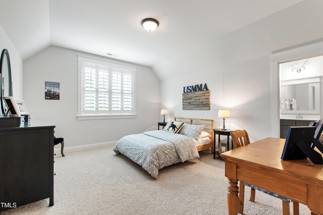 197 Boxwood Dr, Pittsboro, NC 27312 - carpeted bedroom featuring vaulted ceiling, baseboards, and connected bathroom