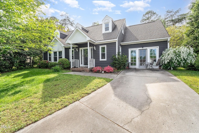 cape cod house with a shingled roof and a front lawn