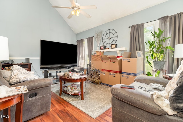 living area with wood finished floors, high vaulted ceiling, and ceiling fan