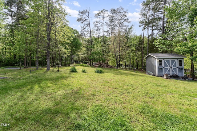 view of yard with an outbuilding and a shed