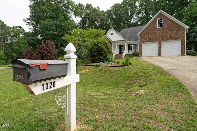 view of front of property with brick siding, a front yard, and concrete driveway