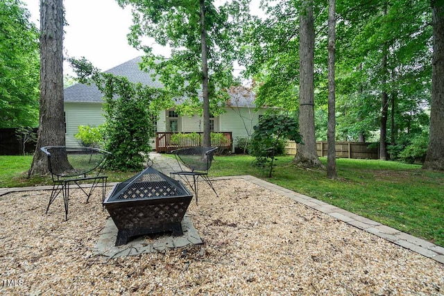 view of patio / terrace featuring a fire pit, fence, and a wooden deck