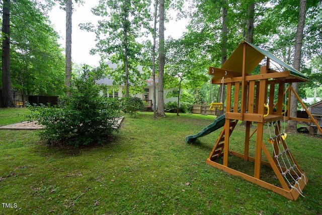 view of play area with fence and a yard