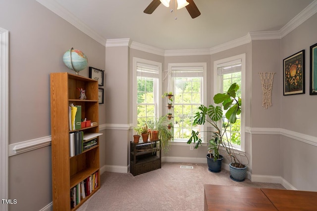 sitting room featuring a ceiling fan, ornamental molding, baseboards, and carpet flooring