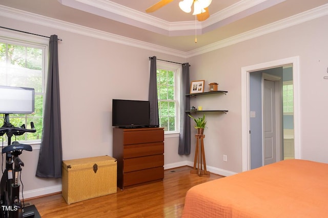 bedroom featuring ornamental molding, wood finished floors, and baseboards