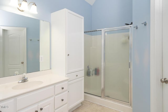 bathroom featuring a shower stall and vanity