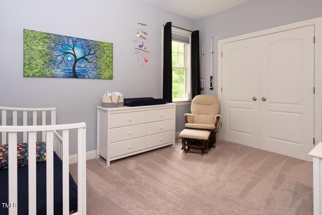 bedroom with light colored carpet and a closet