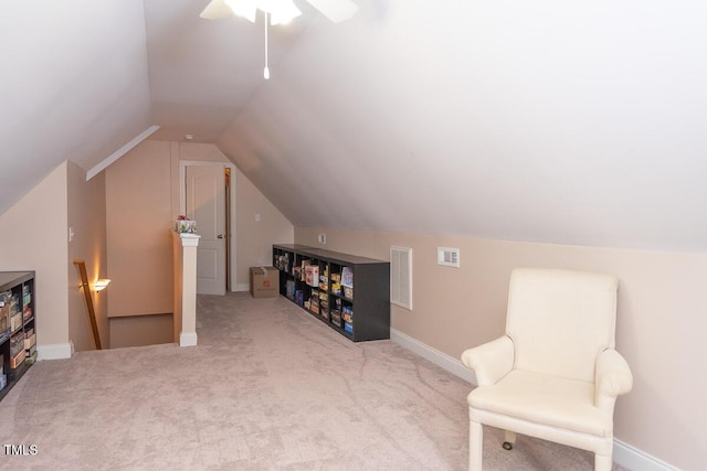 sitting room with an upstairs landing, visible vents, vaulted ceiling, and carpet floors
