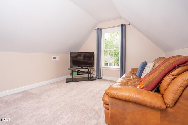 living area with baseboards, visible vents, carpet floors, and lofted ceiling