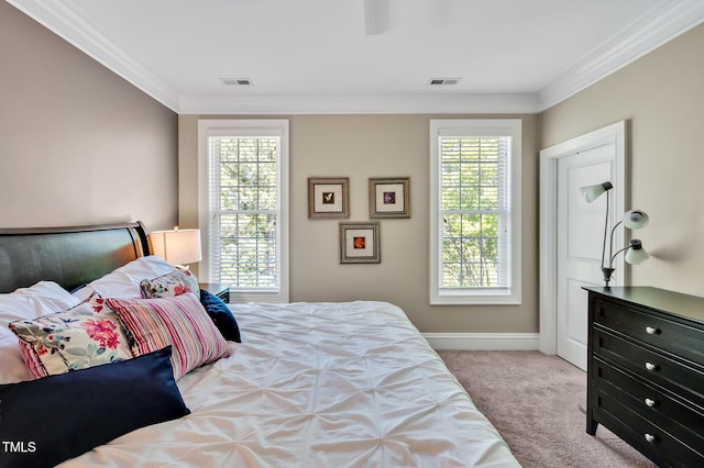 carpeted bedroom featuring crown molding, a ceiling fan, visible vents, and baseboards