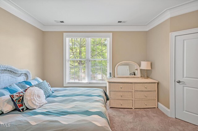 carpeted bedroom with visible vents and ornamental molding