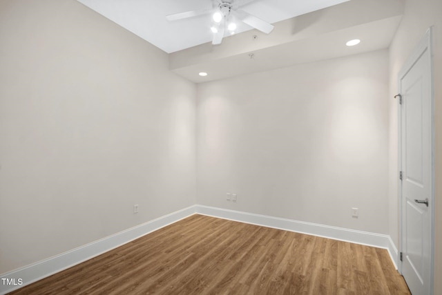 spare room with baseboards, a ceiling fan, wood finished floors, and recessed lighting