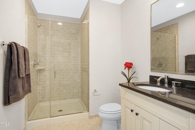 bathroom featuring vanity, tile patterned flooring, a stall shower, and toilet