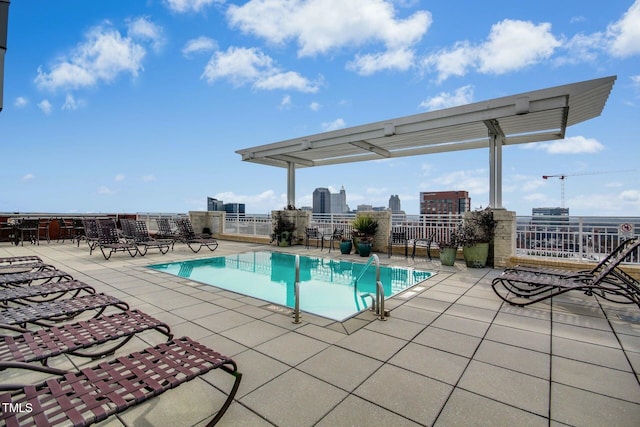 pool with fence and a patio