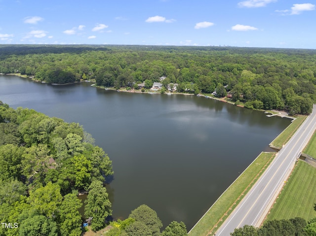 aerial view featuring a water view and a wooded view