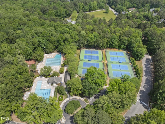 drone / aerial view featuring a wooded view