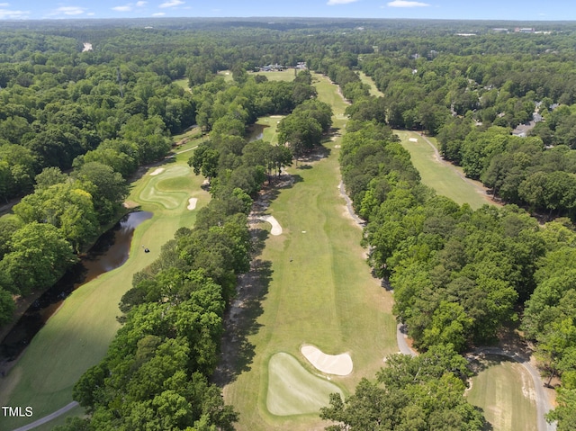 aerial view with a water view, a forest view, and golf course view