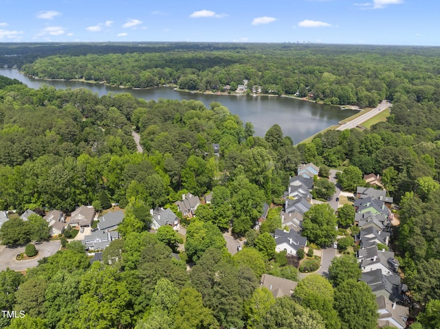 birds eye view of property with a water view, a view of trees, and a residential view