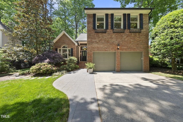 view of front of home with concrete driveway, brick siding, a front lawn, and a garage