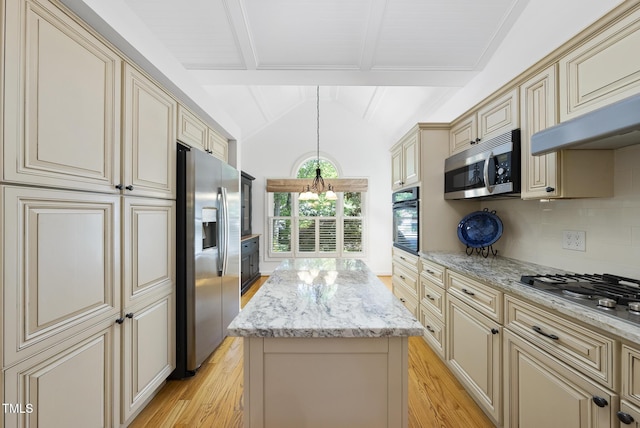 kitchen with cream cabinets, appliances with stainless steel finishes, light wood-style flooring, and a center island