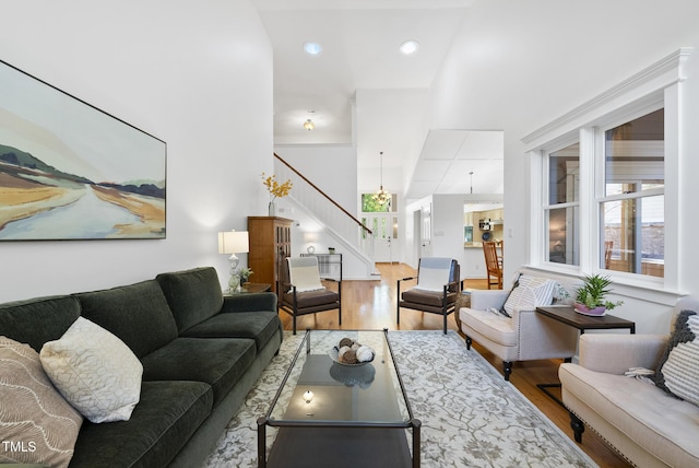 living area with stairs, recessed lighting, and wood finished floors