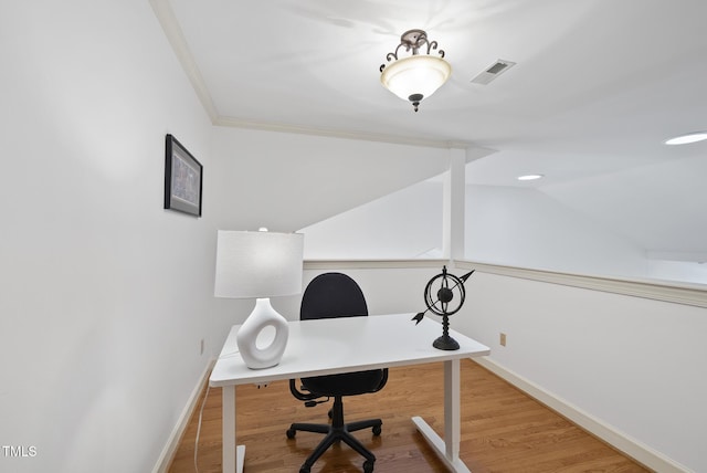 office space featuring visible vents, baseboards, wood finished floors, and vaulted ceiling