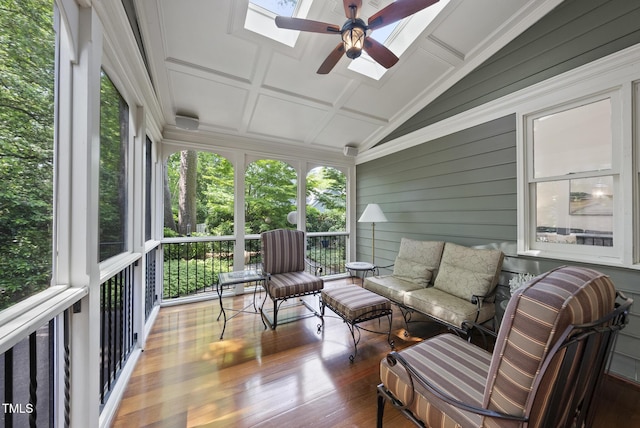 sunroom featuring a skylight, a ceiling fan, and an outdoor hangout area
