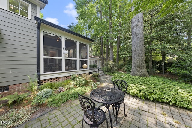 view of patio featuring a sunroom