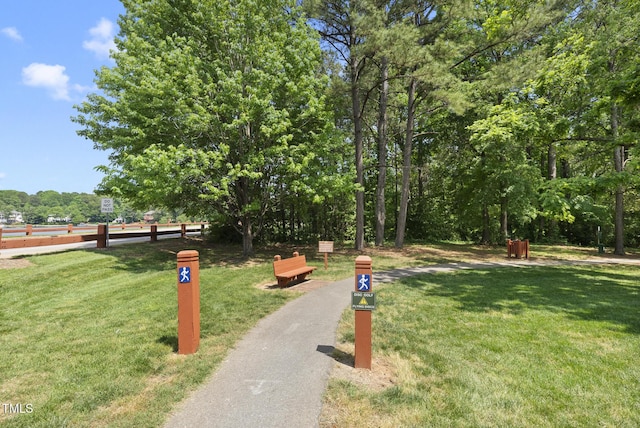 view of home's community featuring a yard and fence