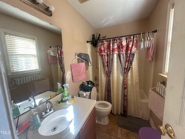 full bathroom with a textured ceiling, tile patterned floors, vanity, toilet, and shower / bath combo with shower curtain