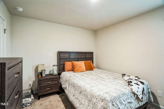 bedroom featuring light carpet