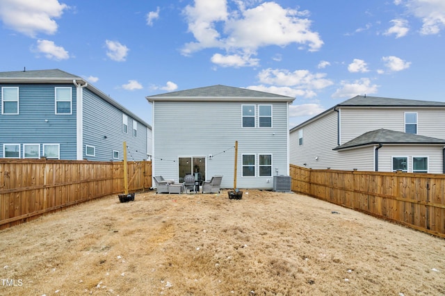 rear view of house featuring a fenced backyard and cooling unit