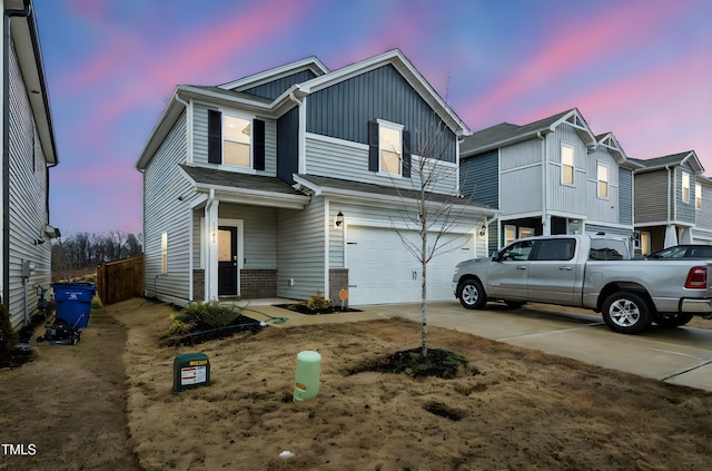 traditional-style home featuring brick siding, driveway, board and batten siding, and a garage