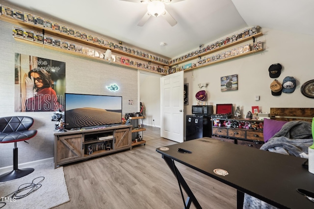 interior space featuring baseboards, ceiling fan, wood finished floors, and vaulted ceiling