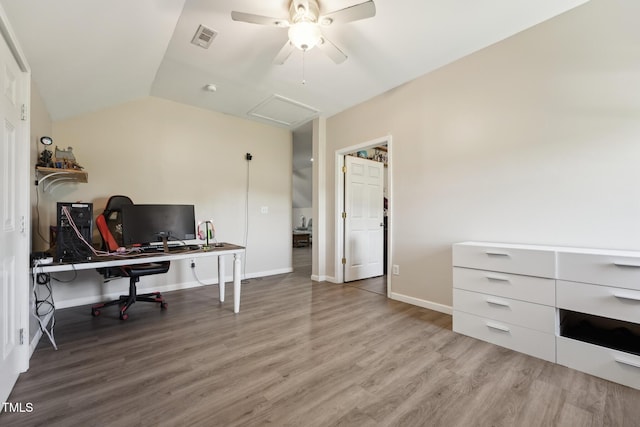 home office featuring a ceiling fan, baseboards, wood finished floors, lofted ceiling, and visible vents