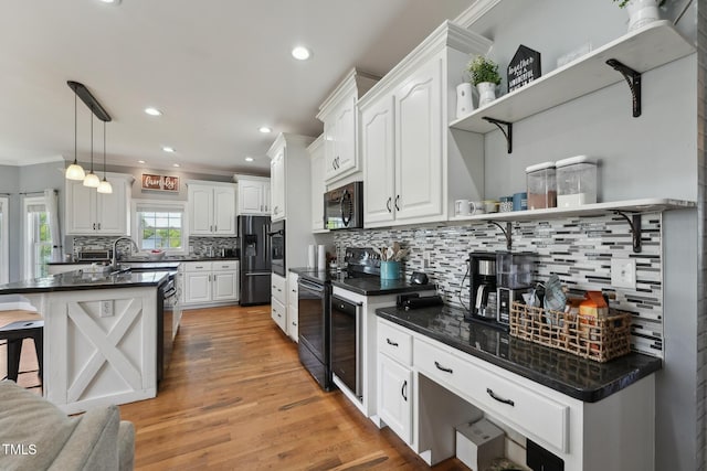 kitchen with decorative backsplash, dark countertops, open shelves, black appliances, and white cabinetry