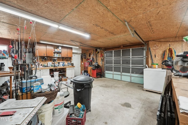 garage with refrigerator and a workshop area