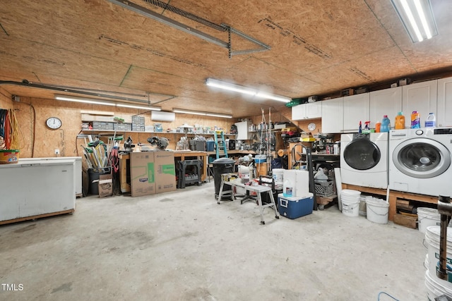 garage with a workshop area and washer and dryer