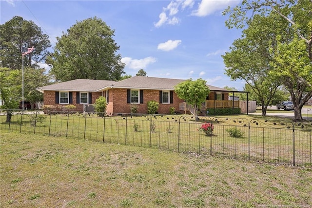 single story home featuring a fenced front yard, brick siding, and a front yard