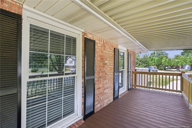 wooden terrace featuring covered porch