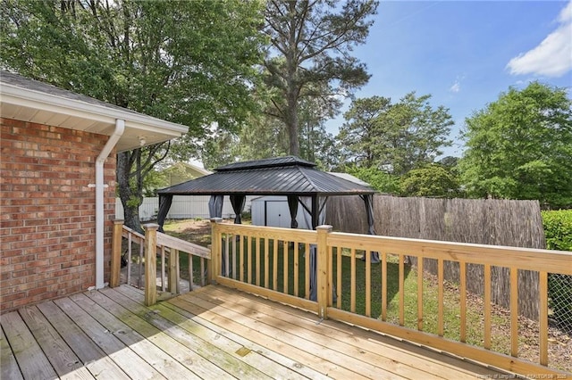 wooden deck with a gazebo and fence