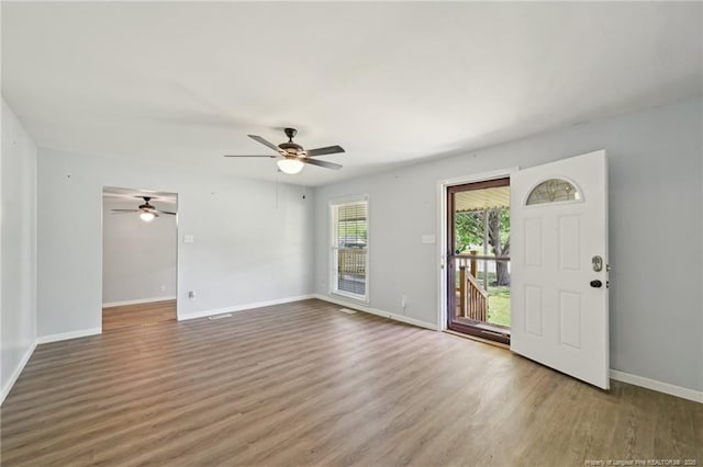 foyer entrance featuring wood finished floors, baseboards, and ceiling fan